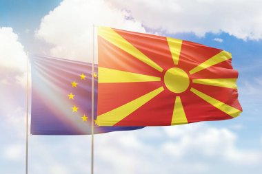 Sunny blue sky and flags of north macedonia and european union