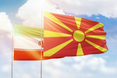 Sunny blue sky and flags of north macedonia and iran