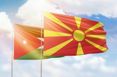 Sunny blue sky and flags of north macedonia and jordan