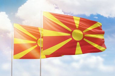 Sunny blue sky and flags of north macedonia and north macedonia
