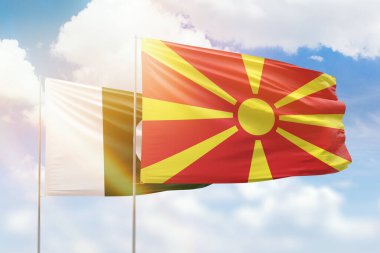 Sunny blue sky and flags of north macedonia and pakistan