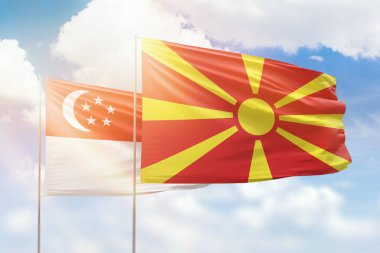 Sunny blue sky and flags of north macedonia and singapore
