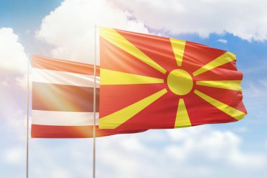 Sunny blue sky and flags of north macedonia and thailand