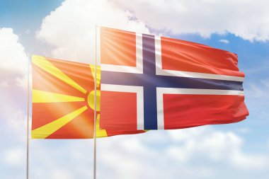 Sunny blue sky and flags of norway and north macedonia