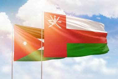 Sunny blue sky and flags of oman and jordan