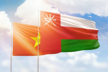 Sunny blue sky and flags of oman and vietnam