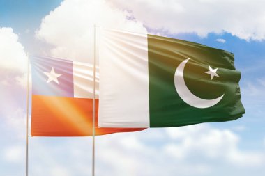 Sunny blue sky and flags of pakistan and chile