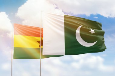 Sunny blue sky and flags of pakistan and ghana