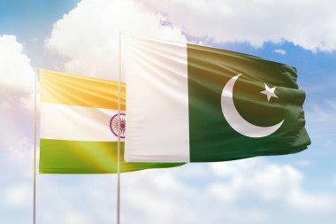 Sunny blue sky and flags of pakistan and india