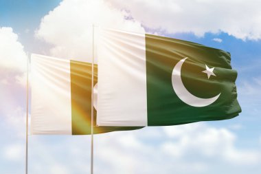 Sunny blue sky and flags of pakistan and pakistan
