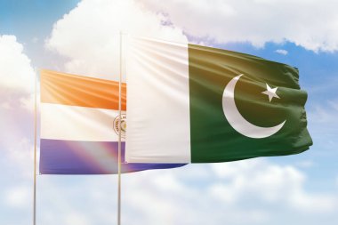 Sunny blue sky and flags of pakistan and paraguay