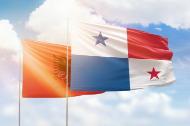 Sunny blue sky and flags of panama and albania