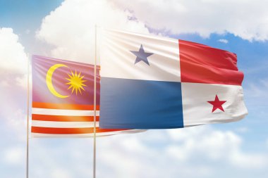 Sunny blue sky and flags of panama and malaysia