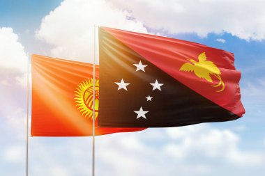 Sunny blue sky and flags of papua new guinea and kyrgyzstan