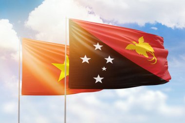 Sunny blue sky and flags of papua new guinea and vietnam