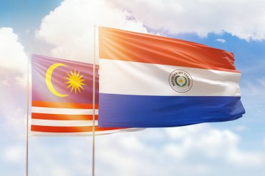 Sunny blue sky and flags of paraguay and malaysia