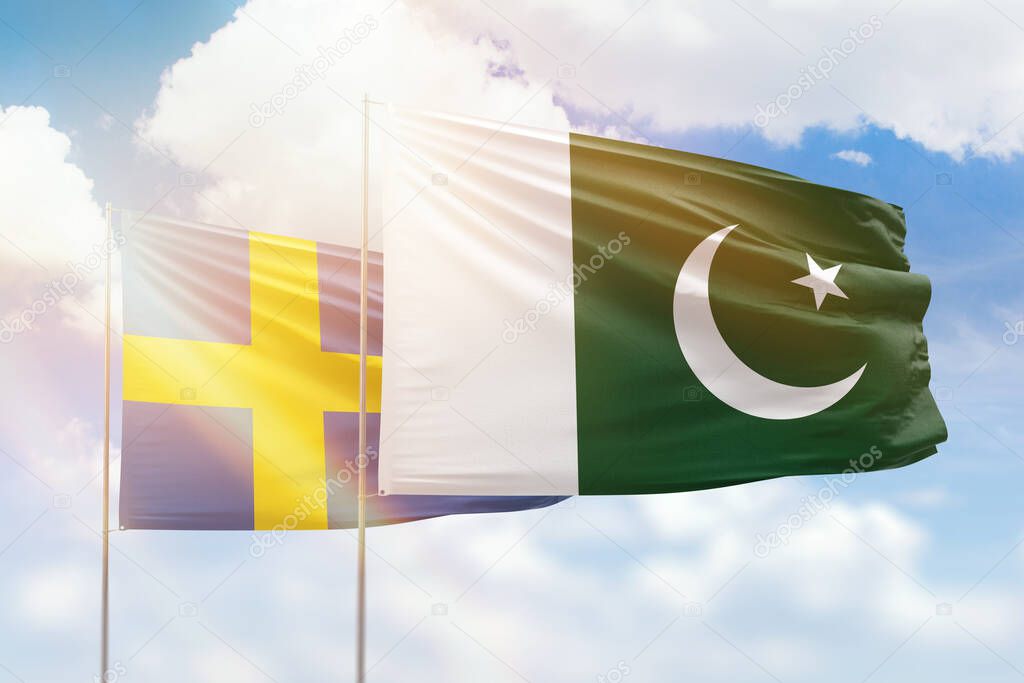Sunny blue sky and flags of pakistan and sweden