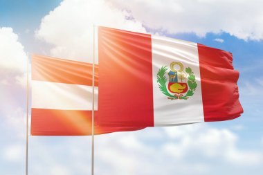 Sunny blue sky and flags of peru and austria