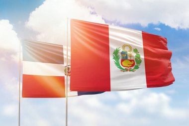 Sunny blue sky and flags of peru and dominican republic