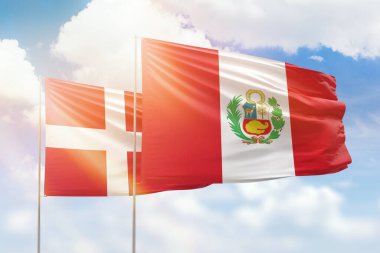 Sunny blue sky and flags of peru and denmark