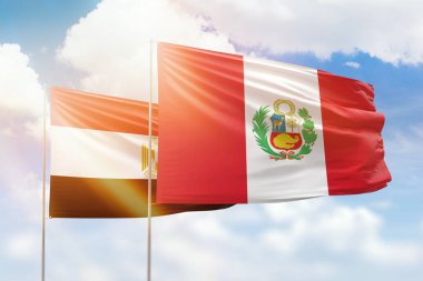 Sunny blue sky and flags of peru and egypt