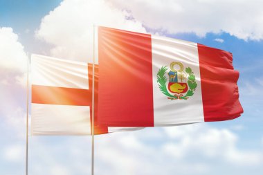 Sunny blue sky and flags of peru and england