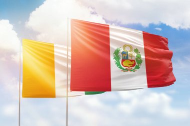 Sunny blue sky and flags of peru and ivory coast