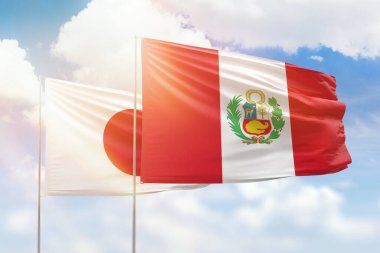 Sunny blue sky and flags of peru and japan
