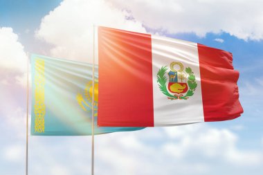 Sunny blue sky and flags of peru and kazakhstan