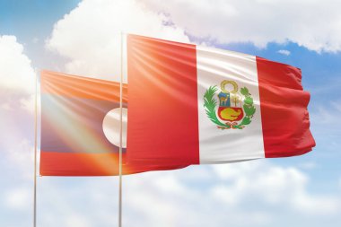Sunny blue sky and flags of peru and laos