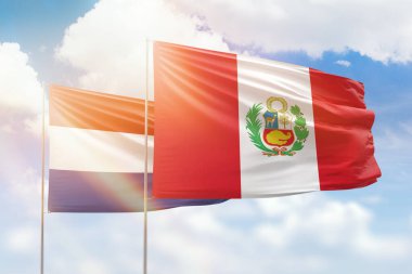 Sunny blue sky and flags of peru and netherlands