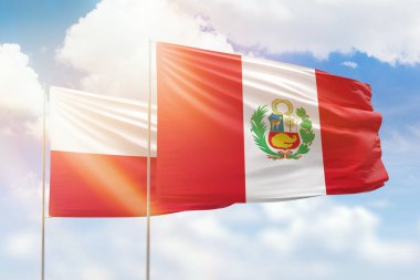 Sunny blue sky and flags of peru and poland