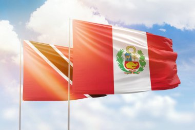 Sunny blue sky and flags of peru and trinidad and tobago