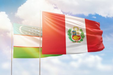 Sunny blue sky and flags of peru and uzbekistan