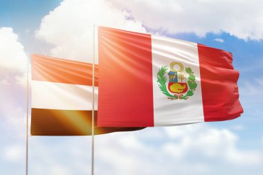 Sunny blue sky and flags of peru and yemen