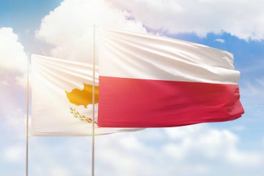 Sunny blue sky and flags of poland and cyprus