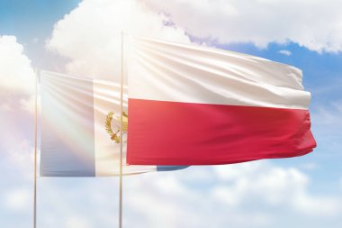 Sunny blue sky and flags of poland and guatemala
