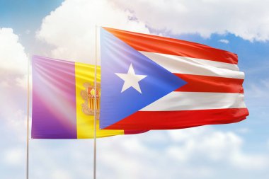 Sunny blue sky and flags of puerto rico and andorra