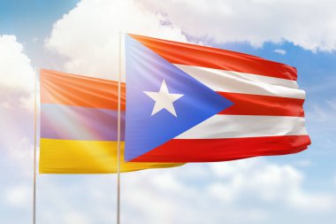 Sunny blue sky and flags of puerto rico and armenia