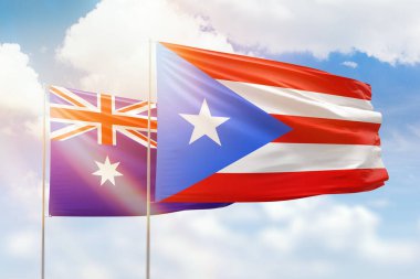 Sunny blue sky and flags of puerto rico and australia