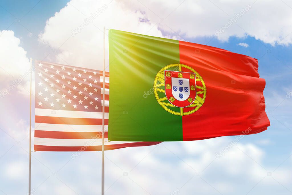 Sunny blue sky and flags of portugal and usa