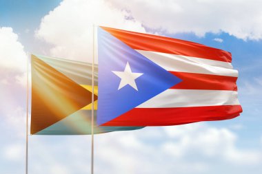 Sunny blue sky and flags of puerto rico and bahamas