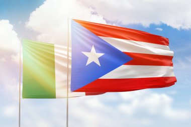 Sunny blue sky and flags of puerto rico and italy