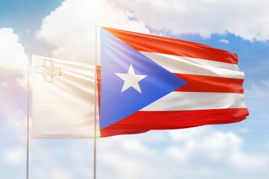 Sunny blue sky and flags of puerto rico and malta