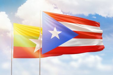 Sunny blue sky and flags of puerto rico and myanmar