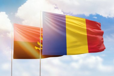 Sunny blue sky and flags of romania and angola