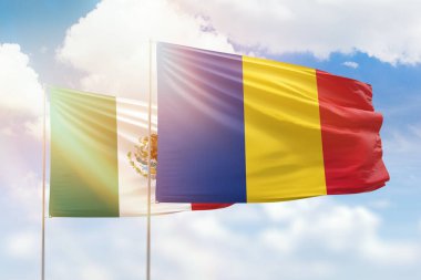 Sunny blue sky and flags of romania and mexico