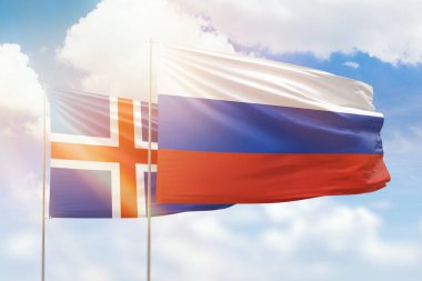 Sunny blue sky and flags of russia and iceland
