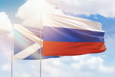 Sunny blue sky and flags of russia and scotland