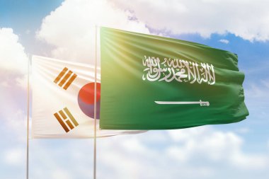 Sunny blue sky and flags of saudi arabia and south korea
